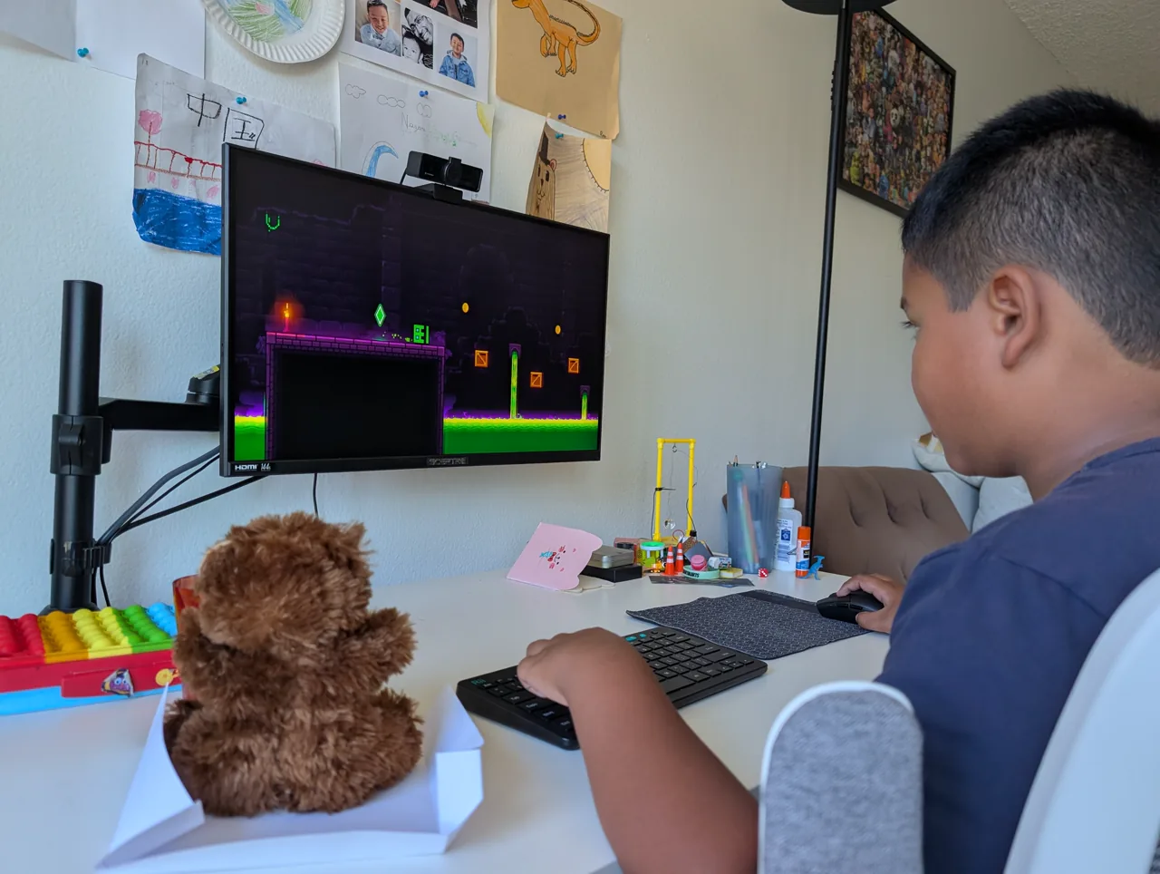 Mr. Bearry watching Ray play Geometry Dash at the computer